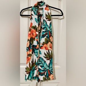 Tropical pattern romper. Open slit in front and back. Ties behind the neck.